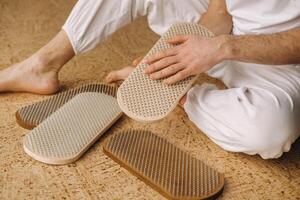 A man holds in his hands boards with nails for yoga classes photo