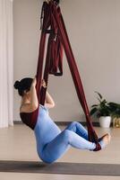 Pregnant girl. A woman does yoga on a hammock in the gym. The concept of a healthy lifestyle, Motherhood photo