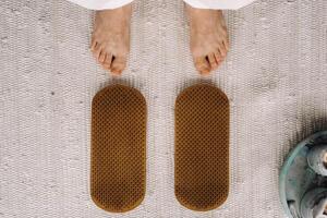 The man's feet are next to boards with nails. Yoga classes photo