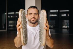 A man holds in his hands boards with nails for yoga classes photo