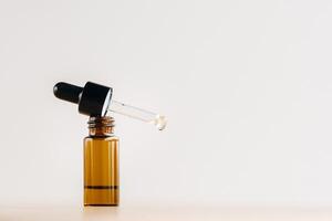 Essential oil in one bottle standing on the surface photo