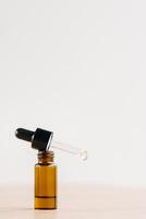 Essential oil in one bottle standing on the surface photo