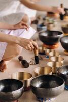 Close-up of a Tibetan singing bowl in your hands - Translation of mantras transform your impure body, speech and mind into a pure exalted body, speech and mind of a Buddha photo