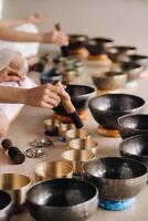 Tibetan singing bowl in your hands - Translation of mantras transform your impure body, speech and mind into a pure exalted body, speech photo