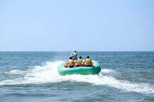 Walk on an inflatable mattress at ocean on a tow of a water motorcycle photo