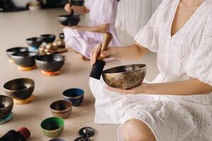 Tibetan singing bowl in your hands - Translation of mantras transform your impure body, speech and mind into a pure exalted body, speech photo