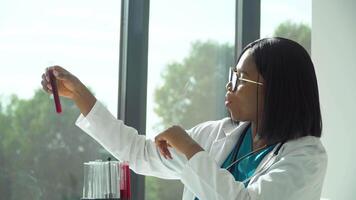 Female african scientist doctor doing blood test in laboratory. Covid 19 test video