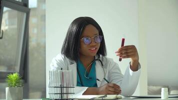 Female african scientist doctor doing blood test in laboratory. Covid 19 test video