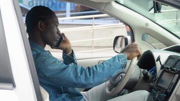 African american man making phone call at luxury car video
