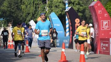 New Delhi, India - October 15 2023 - Vedanta Delhi Half Marathon race after covid in which marathon participants about to cross the finish line, Delhi Half Marathon 2023 video