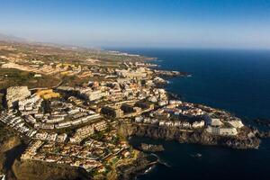 Top view of the houses located on the rock of Los Gigantes at sunset, Tenerife, Canary Islands, Spain photo