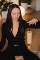 Woman playing to Koshi instrument. singing along, meditating music photo