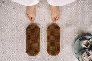 The man's feet are next to boards with nails. Yoga classes photo