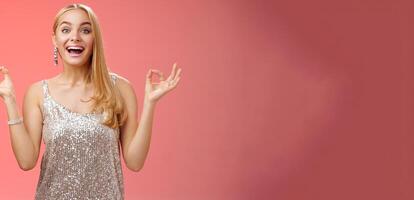 Excited carefree happy stress-free charming blond european woman calm feelings under control show zen gesture standing nirvana lotus pose meditating joyfully smiling, calmd-down red background photo