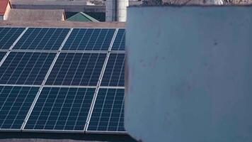 Photovoltaics solar panels on the rooftop of industrial building. Solar panels and blue sky. Solar panels system power generators. Alternative power energy concept. video