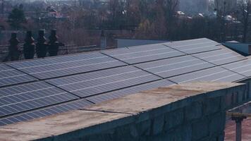 Photovoltaics solar panels on the rooftop of industrial building. Solar panels and blue sky. Solar panels system power generators. Alternative power energy concept. video