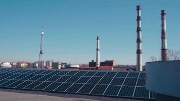 Photovoltaics solar panels on the rooftop of industrial building. Solar panels and blue sky. Solar panels system power generators. Alternative power energy concept. video