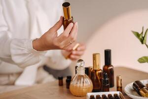 Close-up of female hands holding a bottle of essential oil, Aromatherapy photo