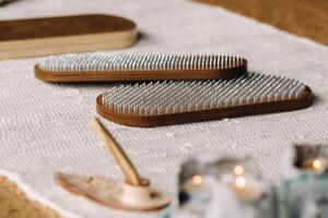 A smoking Palo Santo stick and boards with nails for yoga classes photo