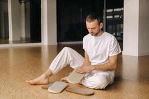 A man holds in his hands boards with nails for yoga classes photo