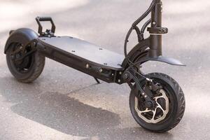 Black Electric scooter standing on the running board on the street photo