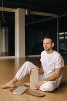 A man holds in his hands boards with nails for yoga classes photo