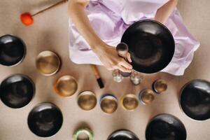 Close-up of a Tibetan singing bowl in your hands - Translation of mantras transform your impure body, speech and mind into a pure exalted body, speech and mind of a Buddha photo