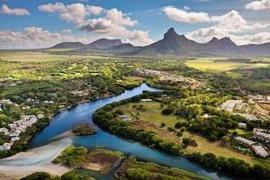 A river flowing into the ocean on the tropical island of Mauritius.Nature on the island of Mauritius, mountains and river of the island of Mauritius photo