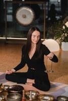 A woman holds Tibetan bells for sound therapy in her hands. Tibetan cymbals photo