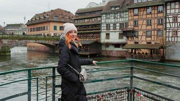 Front view portrait of confident Caucasian calm woman standing on river bridge. video