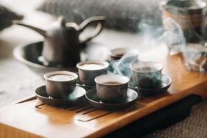 Cups with poured tea before the tea ceremony with incense photo