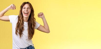 Girl thanks invitation awesome party having fun go wild raise hands up relaxed loose dancing lip sync cool music enjoying moment wear white t-shirt casual outfit celebrating yellow background photo