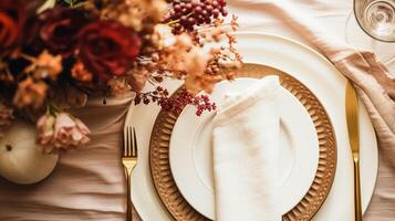 AI generated Autumn holiday tablescape, formal dinner table setting, table scape with elegant autumnal floral decor for wedding party and event decoration photo