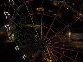 Beautiful sunset over the city with a lighted Ferris wheel. photo