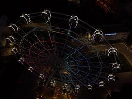 Beautiful sunset over the city with a lighted Ferris wheel. photo