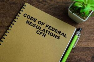 Concept of Code of Federal Regulations CFR write on book isolated on Wooden Table. photo