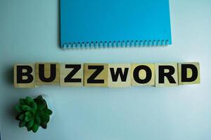 Concept of The wooden Cubes with the word Buzzword on wooden background. photo