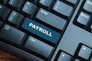 Payroll write on keyword isolated laptop background photo