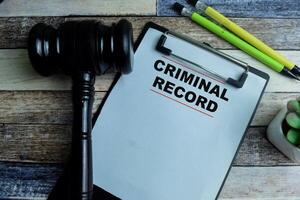 Concept of Criminal Record write on paperwork with gavel isolated on wooden background. photo