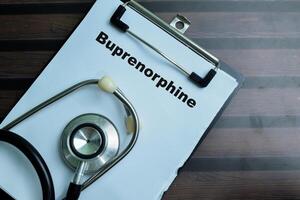 Concept of Buprenorphine write on paperwork with stehoscope isolated on wooden background. photo