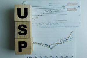 Concept of The wooden Cubes with the word USP on wooden background. photo
