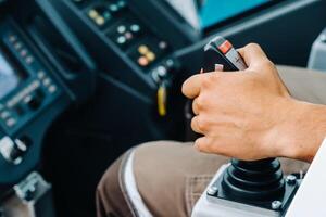 Close-up of a hand holding a joystick to control a crane.Construction concept photo