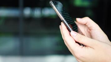 Close up view of hand of woman reading a online book on her smartphone. High quality 4k footage video