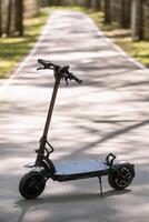 Black Electric scooter standing on the running board on the street photo