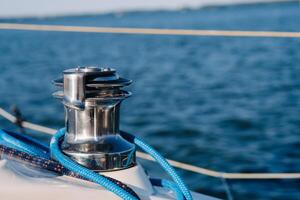 rope on the winch of a white yacht in the sea.yacht equipment photo