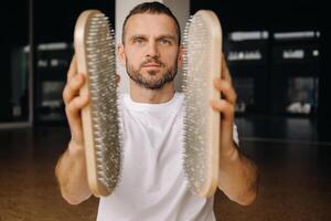 A man holds in his hands boards with nails for yoga classes photo