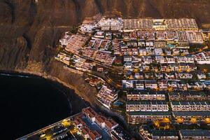 Top view of the houses located on the rock of Los Gigantes at sunset, Tenerife, Canary Islands, Spain photo