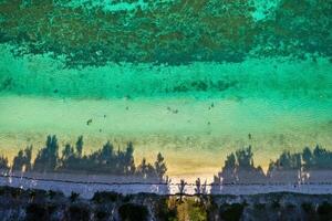 View from the height of the east coast of the island of Mauritius. Flying over the turquoise lagoon of the island of Mauritius in the area of Bel Mare. photo