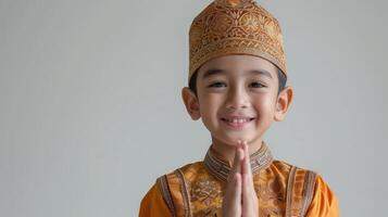 AI generated Cute muslim little asian boy greeting ramadhan isolated on white background.jpg photo