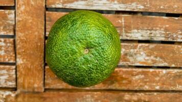 green orange on Rustic Wooden Backdrop photo